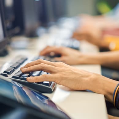 hands typing on keyboard