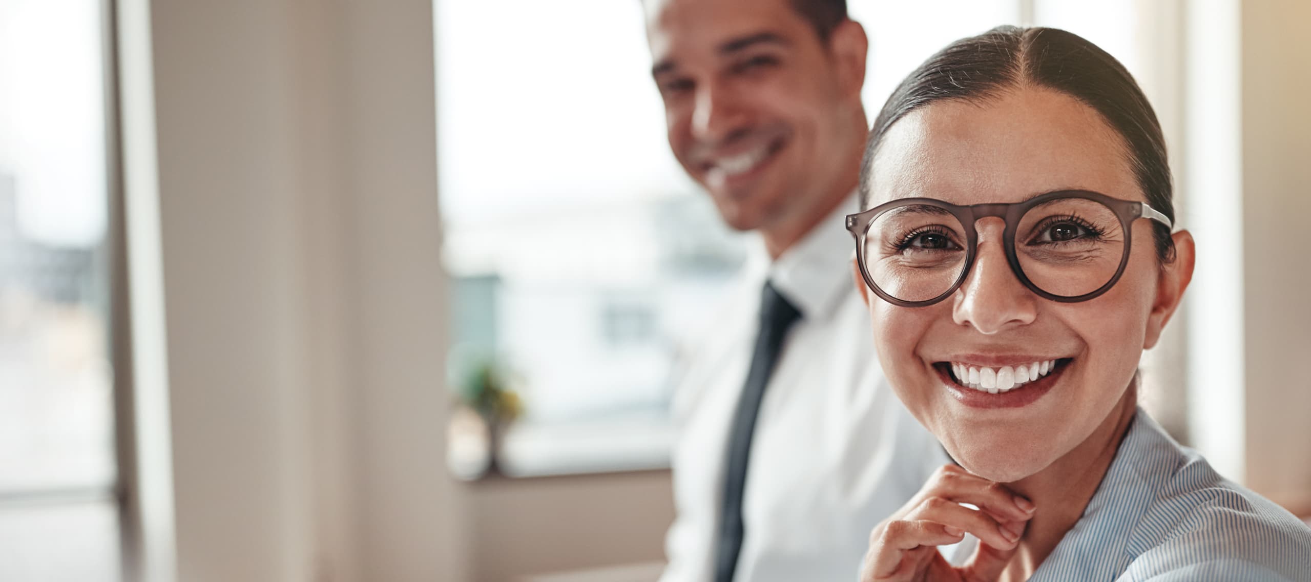 smiling man and woman in business office